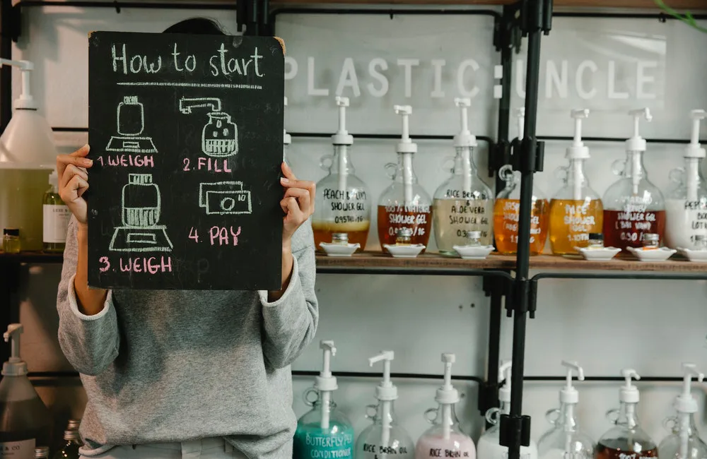 una persona sostiene con un cartel explicativo en un comercio